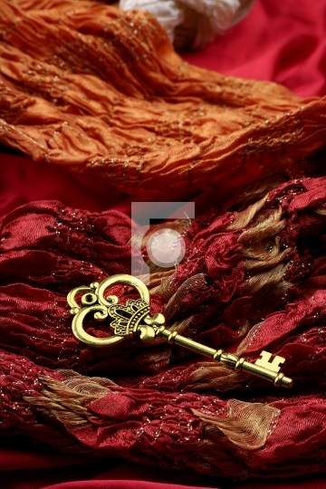 Antique Golden Key on Red Fabric