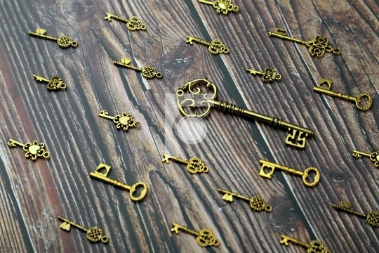 Antique Golden Keys on Wooden Background