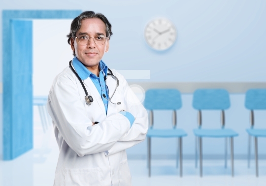 Asian or Indian Doctor wearing glasses with Hospital Background