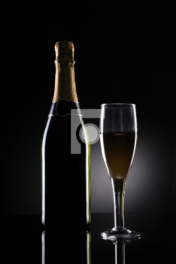 Champagne Bottle and Glass on Black Background