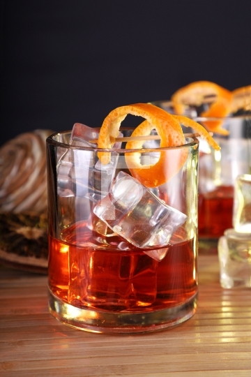 Chilled Alcohol Whisky / Rum Drink with Ice Cube and Orange Peel
