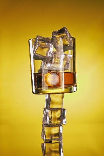 Chilled Whisky Glass on Ice Cubes Creative Shot