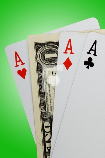 Closeup of three aces and one dollar note