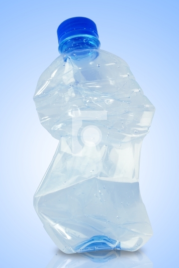 crushed water bottle in blue background