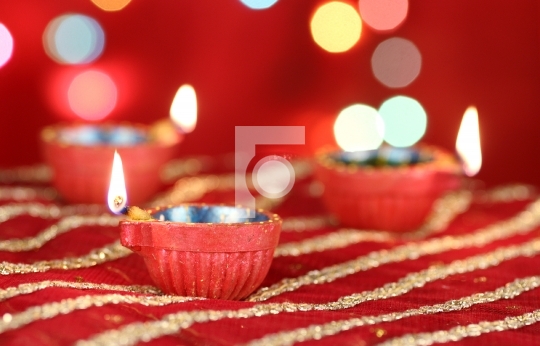 Diwali Diya with blurred festive lights in the background