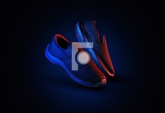 Dramatic shoe pair with blue and red light on dark background