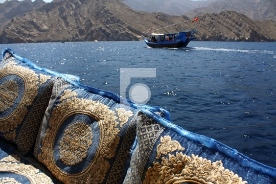 embroidered cushions and dhow cruise in oman waters