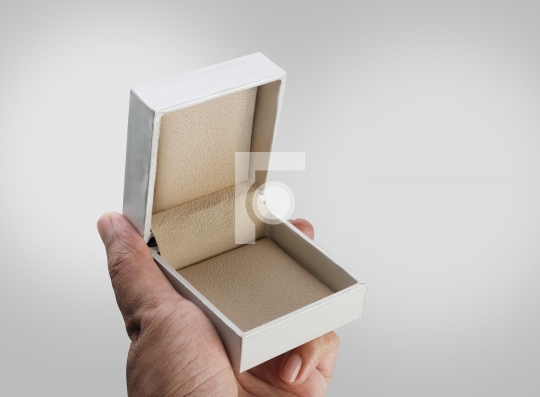 Empty Open White Jewelry Ring Box in a Hand