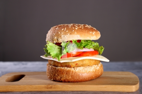Fast Food - Burger on a wooden board