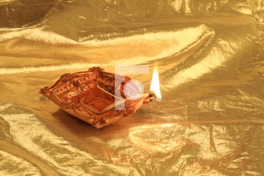 Golden Diwali - Handmade Diya in gold color background