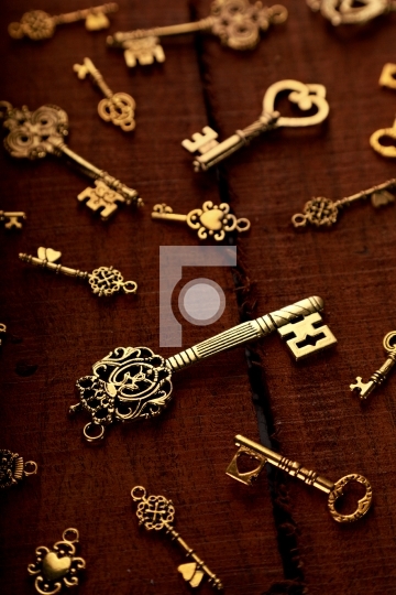 Group of Golden Antique Keys on an old Wood Background