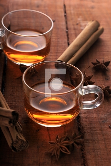 Herbal Tea with Star Anise and Cinnamon in a Cup on Wooden Table