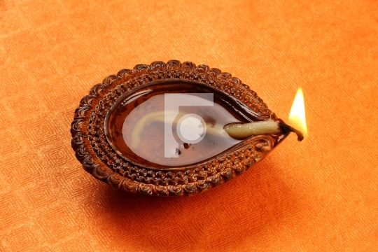 Hindu Festival Diwali Diya on Orange Background