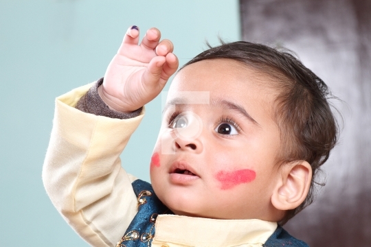 Indian Baby Boy Celebrating Holi with Colour on Face