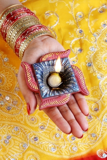 Indian Festival Diwali Diya Lamp in Female Hand