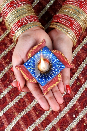 Indian Festival Diwali Diya Lamp Light in Female Hand