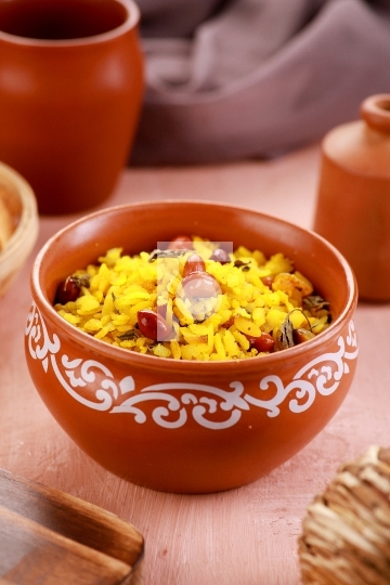 Indian Food Maharashtra Poha with Peanuts in a Pottery Bowl