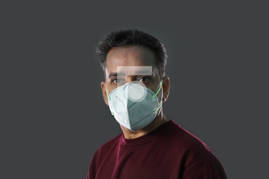 Indian Man wearing a N95 mask for protection against virus, dust