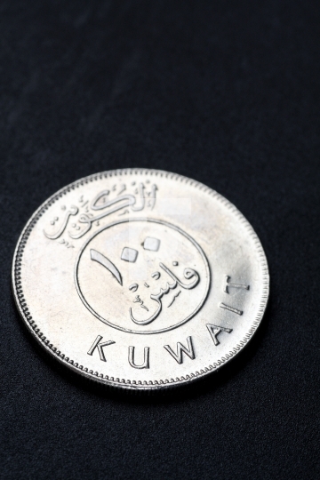 Kuwait 100 dinar coin in black background