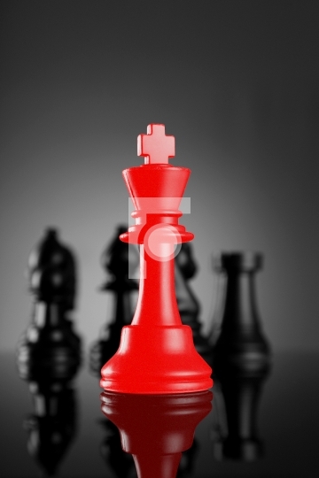 Leadership Red Chess King with pieces on dark background