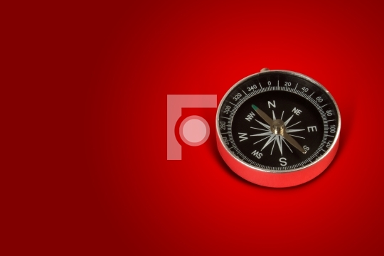 Magnetic compass in red background