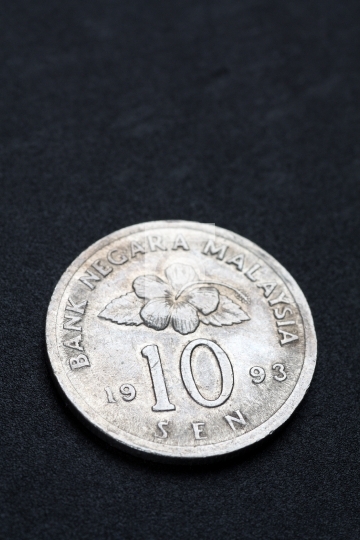 Malaysia coin in black textured background