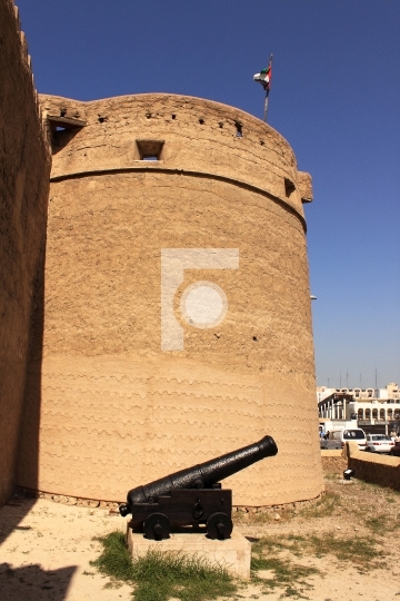 old fort and a antique cannon outside dubai museum, united arab 