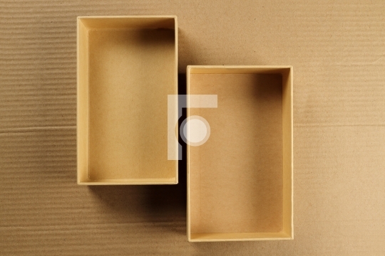 Open Recycled Card Board Box on Corrugated Background