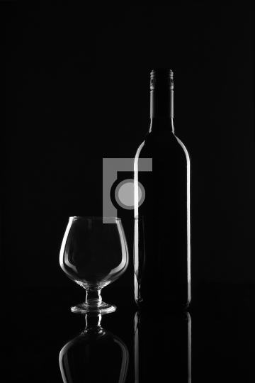 Red Wine Bottle and Glass on Black Background