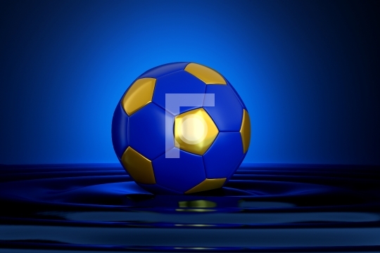 Soccer Ball with Blue and Gold Color in Water Creating Ripples -