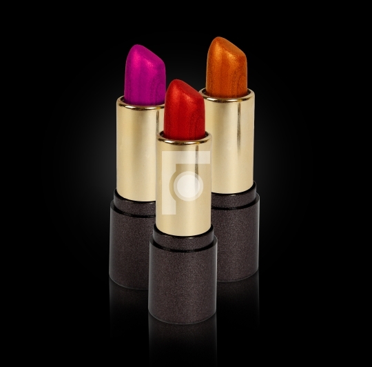 three colored lipsticks