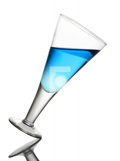 Tilted Wine Glass With Blue Drink on White Background