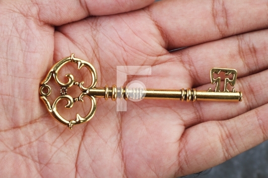 Vintage / Retro Golden Key in a Hand