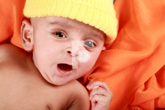 Yawning Baby with a Yellow Hat
