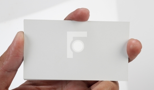 Blank business card in hand