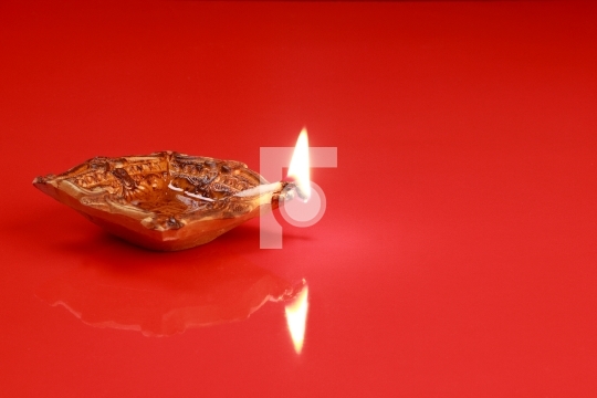 Handmade Diwali Clay Lamp on Red Color Background