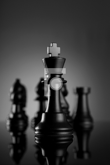 Leadership Chess King with pieces on dark background - Fotonium